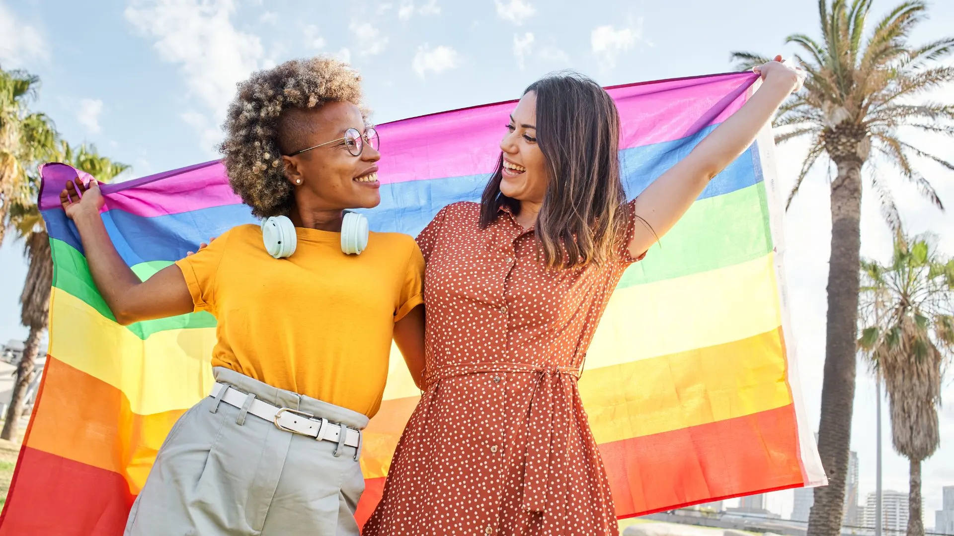 Diverse LGBTQ Couple Holding a Pride Flag